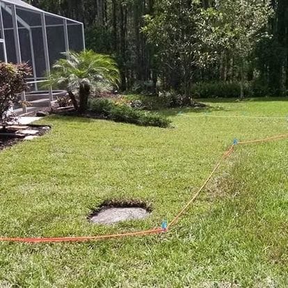 Yard featuring a central hole in the lawn.