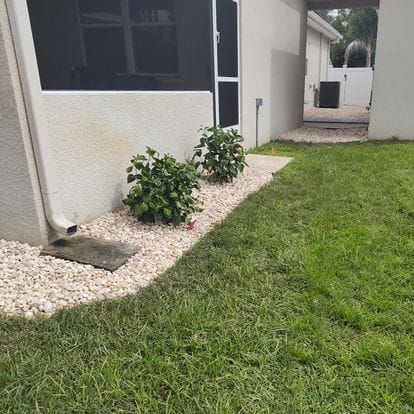 Compact landscaped yard adorned with lush grass and shrubs.